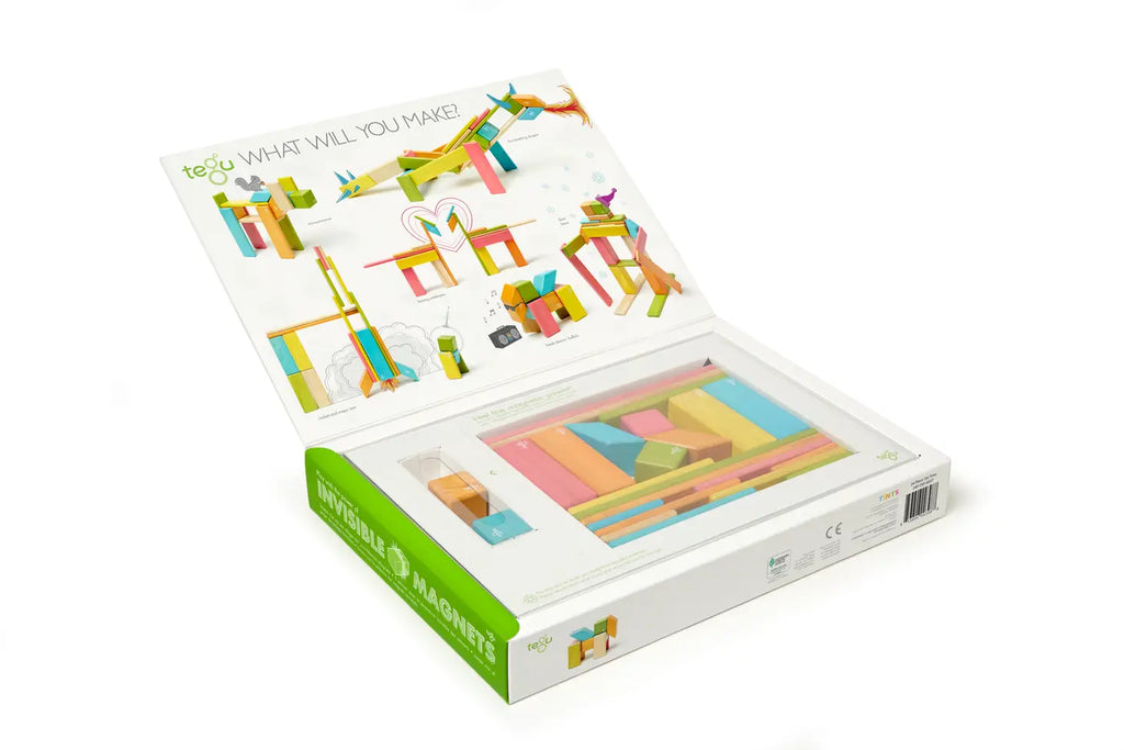 An open box of a Tegu 24 Piece Magnetic Wooden Block Set - Sunset, displaying colorful wooden blocks and an instruction sheet with creative examples like animals and structures.