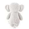 A gray, knitted Cuddle + Kind Baby Elephant is shown from the back. Hand-knit baby animals like this one feature large, floppy ears and a small tail. Its texture suggests it is soft and cuddly, suitable for children. Made with Peruvian cotton yarn, this heirloom-quality toy has a small tag on its side with indistinguishable text.