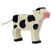 A handcrafted wood toy cow with black and white patches, a pink snout, and a small white tail. The simple, stylized Holztiger Black Calf, Standing figure stands on four legs with a smiling expression, embodying charming European craftsmanship.