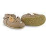 A pair of toddler's light brown moccasin shoes with a squirrel face design, featuring white and tan details, and faux fur textured soles.