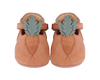 A pair of Donsje Baby Carrot Shoes in tan with a decorative oak leaf accent stitched on each toe, displayed against a black background.