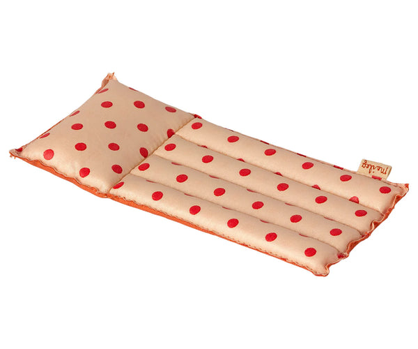 Introducing the Maileg Beach Float, Mouse - Red dot: a rectangular cushion with a soft pillow attached, featuring a beige background adorned with red polka dots. Crafted from coated fabric, this stylish float is segmented into three horizontal sections to ensure both comfort and charm.