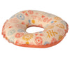 A soft, donut-shaped Maileg Beach Mom Set adorned with colorful floral patterns in red, blue, orange, and yellow. Perfect for a beach house, the Maileg Beach Mom Set has a rough texture and an orange fabric underside.