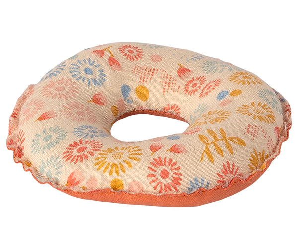 The Maileg Tube, Small Mouse - Flower is a stuffed fabric donut toy that showcases a vibrant pattern of flowers and leaves in shades of blue, red, yellow, and orange. It features an orange underside and a scalloped edge, making it perfect for imaginative play with little mice toys.