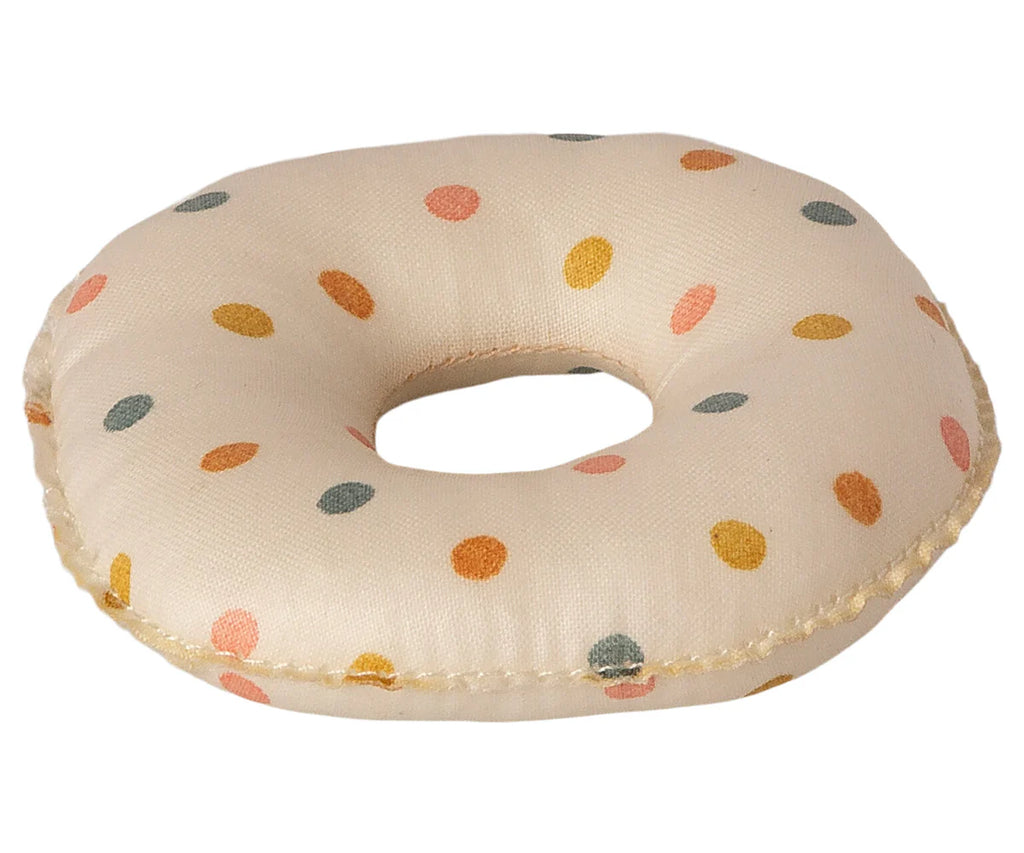 The Maileg Tube, Small Mouse - Multi Dot is a soft, fabric donut-shaped cushion featuring a white base adorned with colorful polka dots in shades of orange, yellow, and teal. Its plush texture and small size make it ideal for giving little mice a cozy resting spot or adding charm to any space.