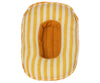 Maileg Beach Raft, Small Mouse - Yellow Stripe: A cushioned, oblong object with yellow and white vertical stripes. It has a rectangular cutout in the center filled with yellow fabric, reminiscent of a small boat or raft. The edges appear stitched, and the item looks soft and plush.