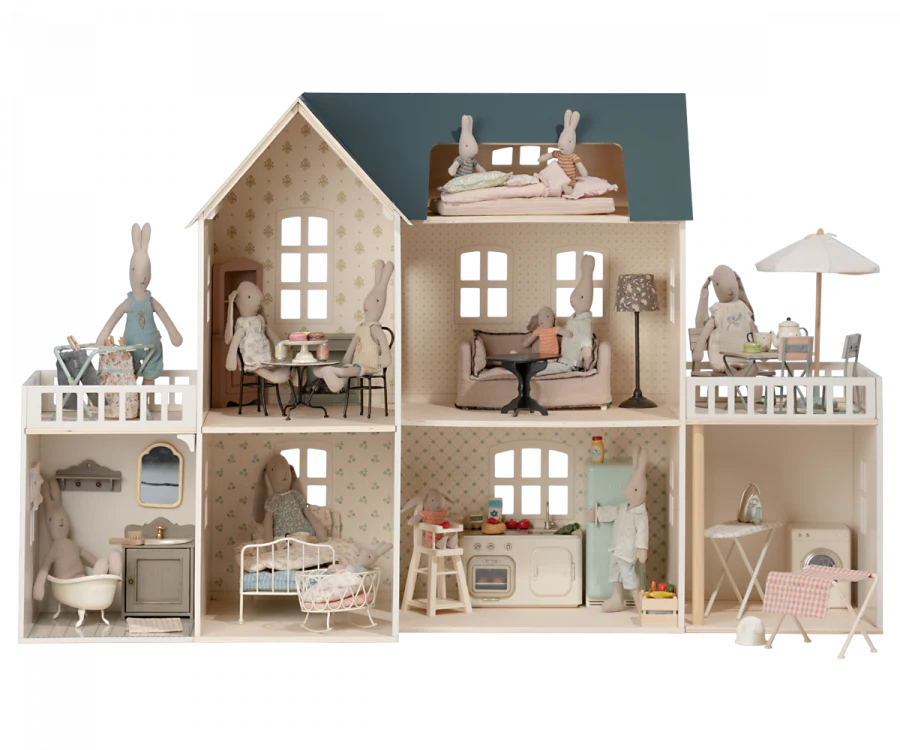 A detailed Maileg Dollhouse with various rooms and furnishings. Each room is occupied by animal-themed dolls engaged in different activities like reading, sleeping, and cooking.