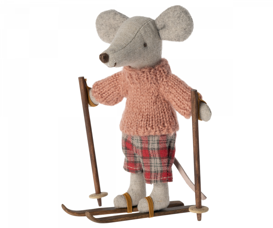 A small gray mouse figure wearing a pink knitted sweater and plaid pants stands on brown skis from the Maileg Christmas Ski and Ski poles For Big Sister & Big Brother set, holding ski poles. The charming mice toy has large ears and a long tail, exuding a cozy, playful winter activity vibe.