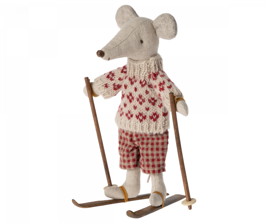 The Maileg Christmas Ski and Ski Poles For Mom & Dad features a stuffed mouse dressed in a cozy cream sweater adorned with red patterns and charming red checkered pants. Standing on wooden skis and holding ski poles, this delightful mouse with its beige fur and playful demeanor perfectly captures the essence of winter fun on the slopes.