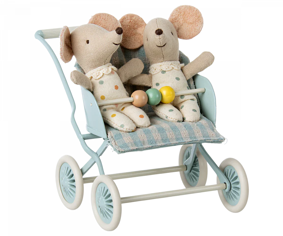 Two stuffed toy mice dressed in polka dot outfits sit side by side in a light blue stroller with four wheels. They each hold onto a colorful bead toy attached to the stroller's handle. Perfect for transport babies or mouse families, the Maileg Stroller, Baby Mice - Mint has a striped fabric seat.