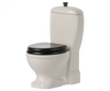 A white ceramic Maileg Miniature Toilet - Teddy Size with a black seat and lid, featuring a traditional design with an attached tank and a flush handle on top. Part of our exclusive bathroom assortment, this toilet boasts a smooth, glossy finish and is isolated on a white background.