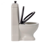 A modern white Maileg Miniature Toilet - Teddy Size with a tall, rectangular flush tank and a black toilet seat, perfect for any bathroom assortment. The toilet seat and lid are both raised. The cistern has a small, round flush handle on top. The word "Piedi" is embossed on the side of the tank.