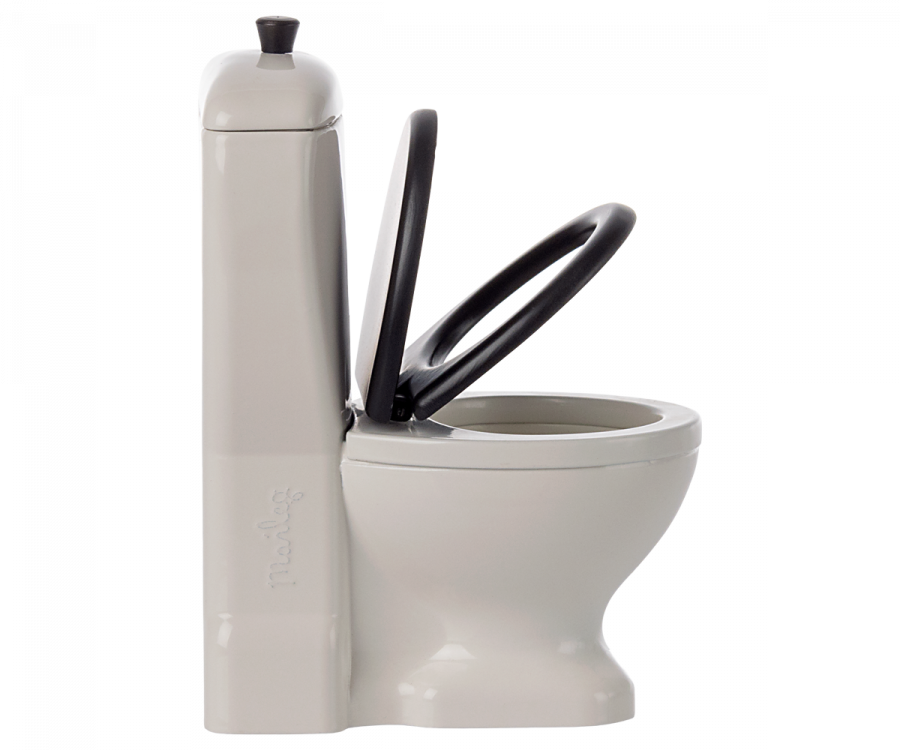 A modern white Maileg Miniature Toilet - Teddy Size with a tall, rectangular flush tank and a black toilet seat, perfect for any bathroom assortment. The toilet seat and lid are both raised. The cistern has a small, round flush handle on top. The word "Piedi" is embossed on the side of the tank.