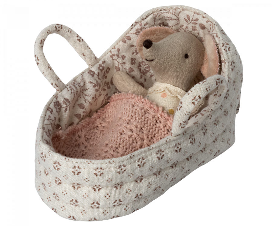 A small stuffed mouse cuddled in a cozy, floral-patterned fabric bassinet with a knitted pink blanket. The mouse appears to be comfortably resting or sleeping in the soft Maileg Carry Cot, Baby.