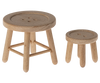 Two wooden stools with round, button-like seats bring rustic charm to any space. The larger stool boasts four legs with diagonal supports, while the smaller stool stands on three legs. Picture them nestled in a cozy corner beside your Maileg Christmas Set for holiday surprises.