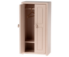 A light rose Maileg Mouse Closet with one door slightly open, displaying a solitary golden hanger. This closet is enhanced with a decorative knob and includes two compartments at the bottom, making it an ideal choice for a mice family’s wardrobe or as an enchanting children's toy.