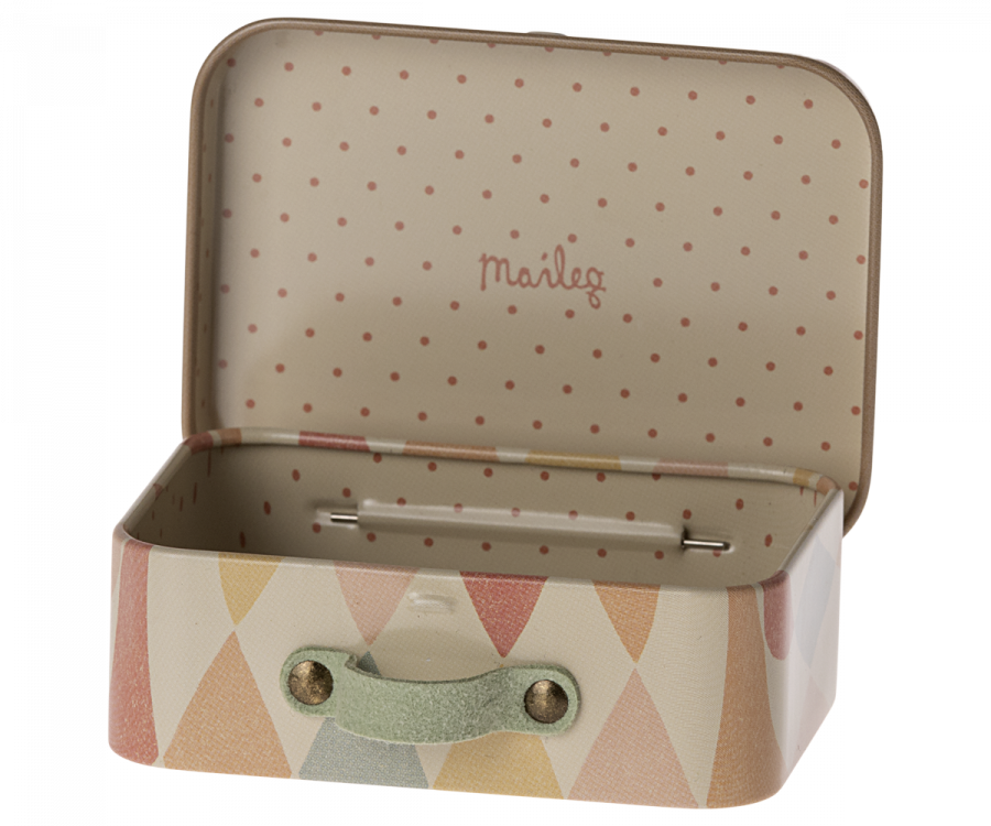 The Maileg Suitcase, Micro is a small rectangular metal suitcase featuring a colorful exterior with a triangular pattern and an interior adorned with polka dots. The lid is open, revealing the ideal space for storing small items. The inner side of the lid is printed with the brand "Maileg," and it has a simple green handle.