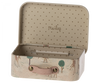 Introducing the Maileg Suitcase, Micro: a charming small metal suitcase featuring a beige polka dot interior. Its exterior boasts colorful illustrations of a whimsical forest scene with trees and deer. The pink handle is secured with brass buttons, adding to its delightful design. Ideal for storing small items, the back panel inside proudly displays the word "Maileg.