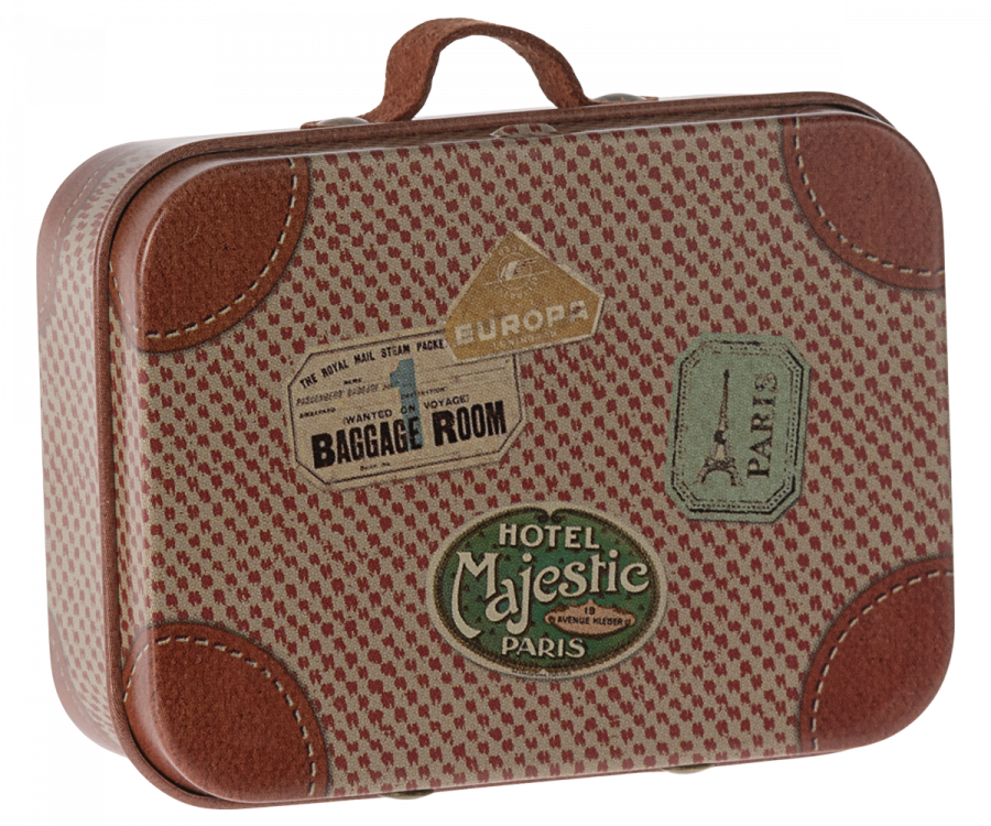 The Maileg Suitcase, Micro is a vintage-style small metal suitcase with brown leather accents and colorful illustrations, adorned with travel stickers from various destinations such as "Hotel Majestic Paris" and "Baggage Room." Perfect for storing small items, it also features a sturdy handle on top.