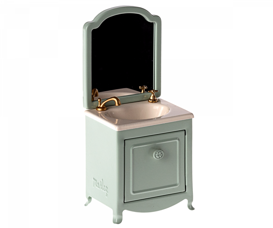 A royal bathroom-worthy, vintage-style Maileg Sink Dresser With Mirror, Mouse. The sink has a white basin with brass faucets, a mint green cabinet with a decorative design on the door below, and the word "maileg" embossed on the lower left corner—perfect for any Maileg mouse castle.