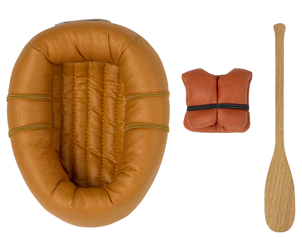 A small, brown, Maileg Rubber Boat with textured seating, a matching fabric life vest, and a single wooden oar. All items are arranged neatly on a white background, ready for a pretend water adventure.