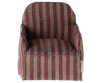 A small, Maileg Chair, Mouse - Striped with red and gray vertical lines, designed in a miniature scale. Perfect for a Gingerbread House setting or to accompany Maileg friends, it features a cushioned seat and backrest ideal for dollhouse or miniature room displays.