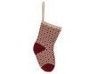 The Maileg Christmas Stocking - Red is a decorative holiday stocking featuring a red and beige woven pattern adorned with diamond shapes. It includes red accents on the heel and toe, has a beige loop at the top for hanging, and is perfect for holding small gifts.