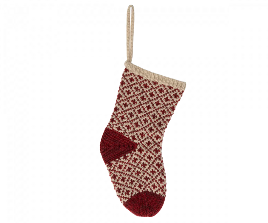 The Maileg Christmas Stocking - Red is a decorative holiday stocking featuring a red and beige woven pattern adorned with diamond shapes. It includes red accents on the heel and toe, has a beige loop at the top for hanging, and is perfect for holding small gifts.