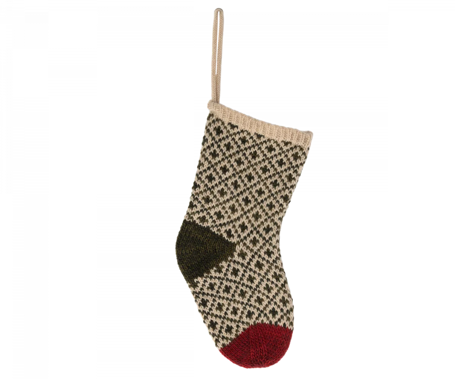 The Maileg Christmas Stocking - Green, featuring a beige background adorned with a black diamond pattern, hangs elegantly by a loop. With a dark green heel and a red toe, it is ideal for holding small gifts.