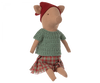 The Maileg Christmas Pig - Girl is a cozy plush piglet, dressed in a festive red hat, green knitted sweater, and red plaid skirt, sitting upright and perfect for the holiday season.