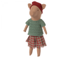 The Maileg Christmas Pig - Girl is a cozy pig plush toy dressed in a festive red hat, green knitted sweater, and a plaid skirt, making it perfect for the holiday season.