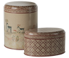 As part of the Maileg Metal Box, 2 Piece Set - Winter Wonderland, these decorative tins feature intricate designs. The taller tin is adorned with deer, trees, and snowflakes on a cream background, while the smaller tin displays a geometric mosaic pattern in earthy tones—perfect for storing Christmas sweets.