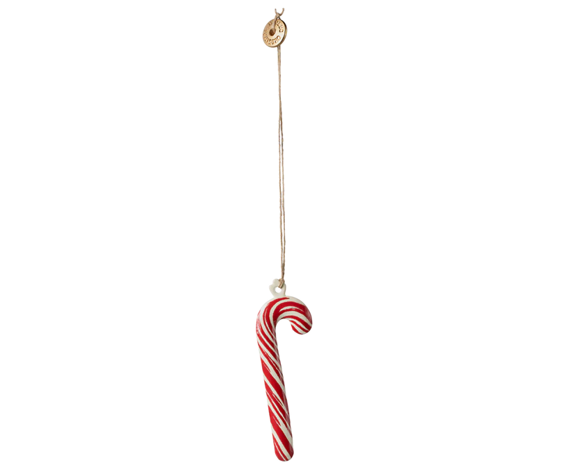 A vertical timeline illustrating the development of candy canes. It begins with a plain white stick representing the 17th century, moves to a simple hook for the 18th century, and concludes with a modern red and white striped candy cane representing the 19th century, highlighted by the delightful Maileg Christmas Metal Ornament - Sugar Cane - Stripe.