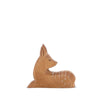 A small handcrafted wooden figurine of a fawn is depicted against a plain white background. The fawn, reminiscent of Ostheimer designs, lies down with its legs tucked underneath its body. It has a smooth finish with light brown color and delicate white spots on its back, perfect for imaginative play.