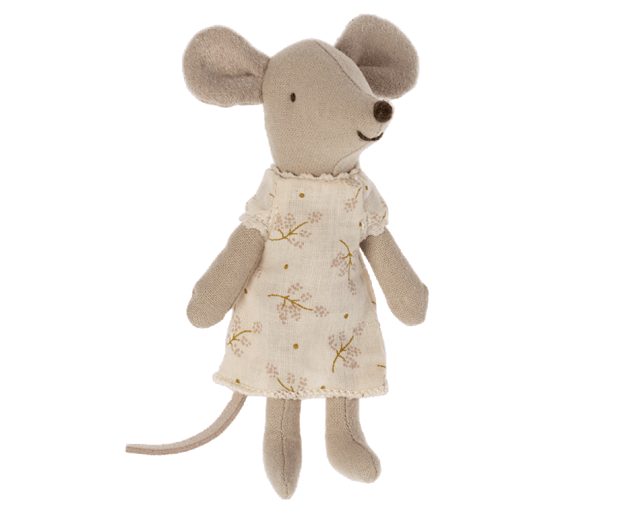 A Maileg little sister mouse wearing a beige Nightgown, standing upright against a black background. The mouse has large ears, a long tail, and a soft, textured body.