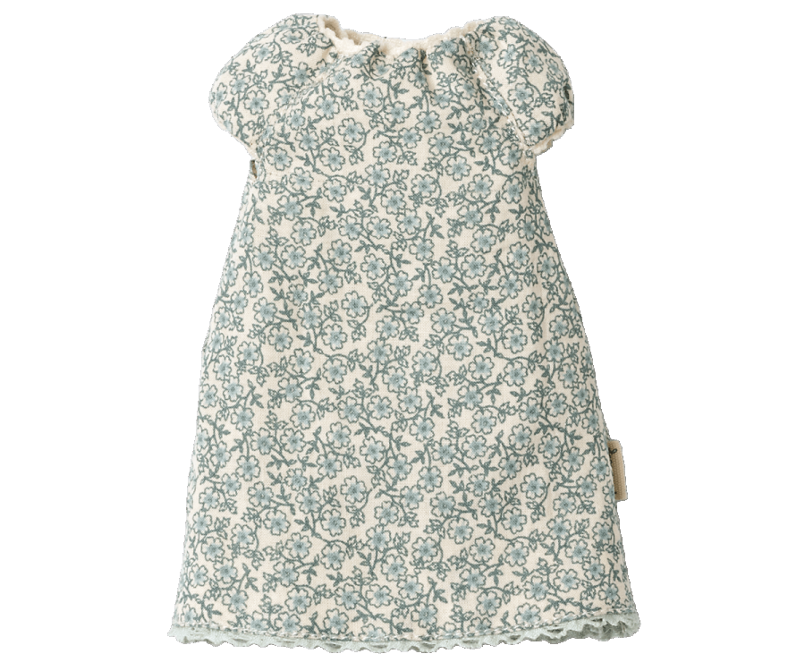 A short-sleeved baby dress with a floral pattern in blue on a white background. The outfit has a simple, loose fit with a ruffled neckline and slightly puffed sleeves. Pair it with the Maileg Extra Clothing: Nightgown for Teddy Mum, which can be purchased separately.