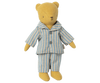 Teddy Junior, a fabric teddy bear with a simplistic design featuring stitched facial features and arms slightly extended to the sides, is wearing Maileg Extra Clothing: Pyjamas for Teddy Junior. The blue and white striped pajamas can be purchased separately for an added touch of charm.