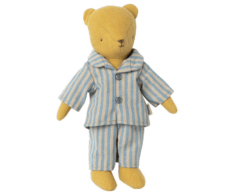 Teddy Junior, a fabric teddy bear with a simplistic design featuring stitched facial features and arms slightly extended to the sides, is wearing Maileg Extra Clothing: Pyjamas for Teddy Junior. The blue and white striped pajamas can be purchased separately for an added touch of charm.