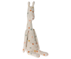 A beige Maileg Medium Giraffe plush made from recycled polyester rests against a surface. Its long neck, ears, and limbs are elegantly adorned with orange, green, and blue polka dots, making it the perfect safari companion with its charming and playful design.