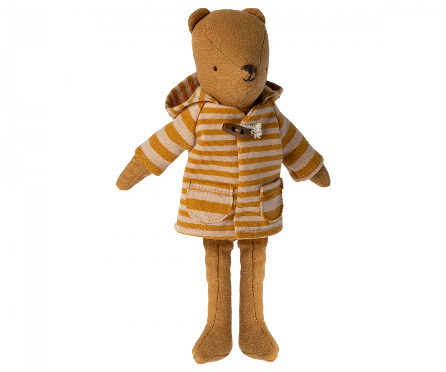 Experience the charm of the Maileg Extra Clothing: Coat for Teddy Mum, a plush teddy bear adorned in a mustard and white striped hoodie with ocher highlights, tiny pockets, and a sturdy wooden closure. Crafted from soft fabric, this bear's face is designed with simple, minimalistic embroidered features.