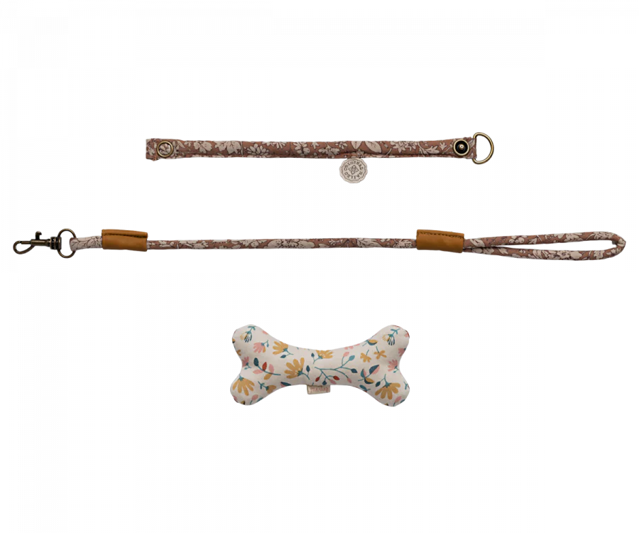 A set of Maileg Puppy Accessories - Rose including a brown floral patterned collar and matching leash, perfect for your plush dog. The included bone-shaped toy features a floral pattern in various pastel colors. The collar has a small circular tag, and the leash includes a metal clip.