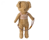 A vintage-style teddy bear dressed in a cozy beige harness with "Benny" embroidered in cursive. The bear is holding a patterned leash in its left paw and stands upright against a plain white background. The fur is light brown, and the Maileg Puppy Supply, Harness exudes a nostalgic charm, reminiscent of beloved puppy supplies.