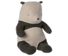 The Maileg Panda Stuffed Animal, Medium is a soft, stuffed bear resembling a panda with a beige face and torso, complemented by black ears, arms, and legs. Crafted from cotton, this adorable bear features a small embroidered nose and eyes that give it an irresistibly cute and cuddly appearance. It sits upright with its legs extended in front.