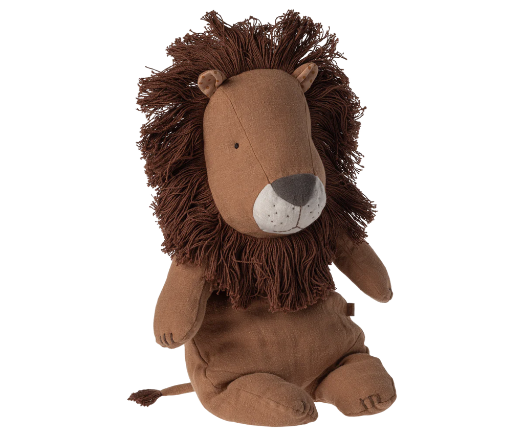 The Maileg Lion Stuffed Animal, part of the delightful Safari Friends collection, sits upright with a large brown mane. It boasts handmade details such as embroidered eyes, nose, and mouth on its light brown face. The body, mane, and tail are made from soft fabric.