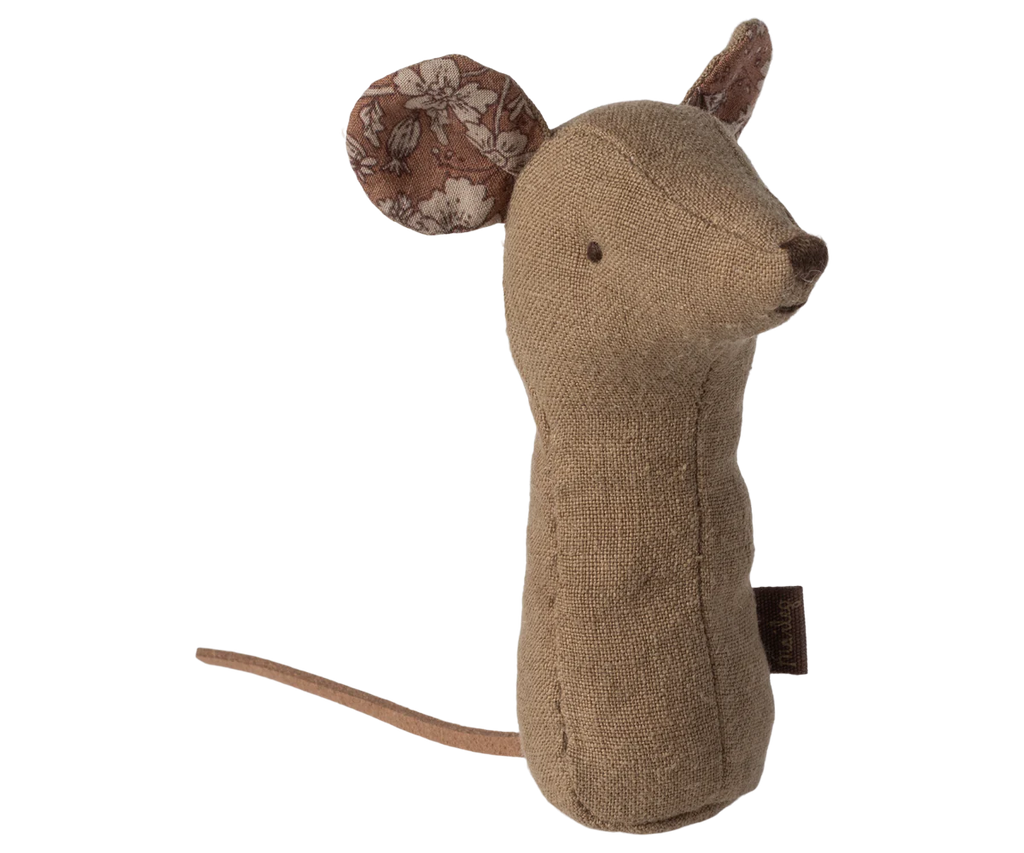 The Maileg Lullaby Friend Rattles, Mouse Rattle - Light Umber is a charming fabric mouse plush toy standing upright, featuring beige and brown floral-patterned ears, a stitched nose and eyes, and a long thin tail. Made from soft fabrics with a burlap-like texture for a rustic, handmade look, this delightful toy can also double as an adorable baby rattle.