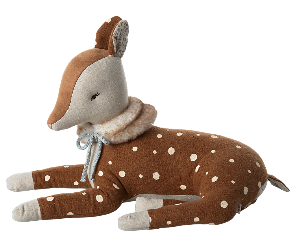 The Maileg Cosy Bambi - Mint is a soft, plush toy deer resting on its legs, featuring a brown body with white polka dots, and light gray snout and ears. It has a fluffy collar around its neck tied with a blue ribbon, giving it an adorable and endearing appearance—perfect for decoration or play.