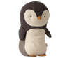 The Maileg Penguin Stuffed Animal - Small is a cuddly toy made from gentle fabrics, showcasing a dark gray back and wings, a white belly, and an orange beak and feet. Suitable for all ages, this charming penguin stands upright with simple embroidered eyes.