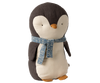 Introducing the Maileg Penguin Stuffed Animal - Medium, this adorable plush showcases a dark grey back and white belly complemented by a playful blue patterned scarf. Crafted from soft fabrics, it features charming details like a small orange beak and flippers, standing proudly against a plain backdrop. A delightful companion for all ages!