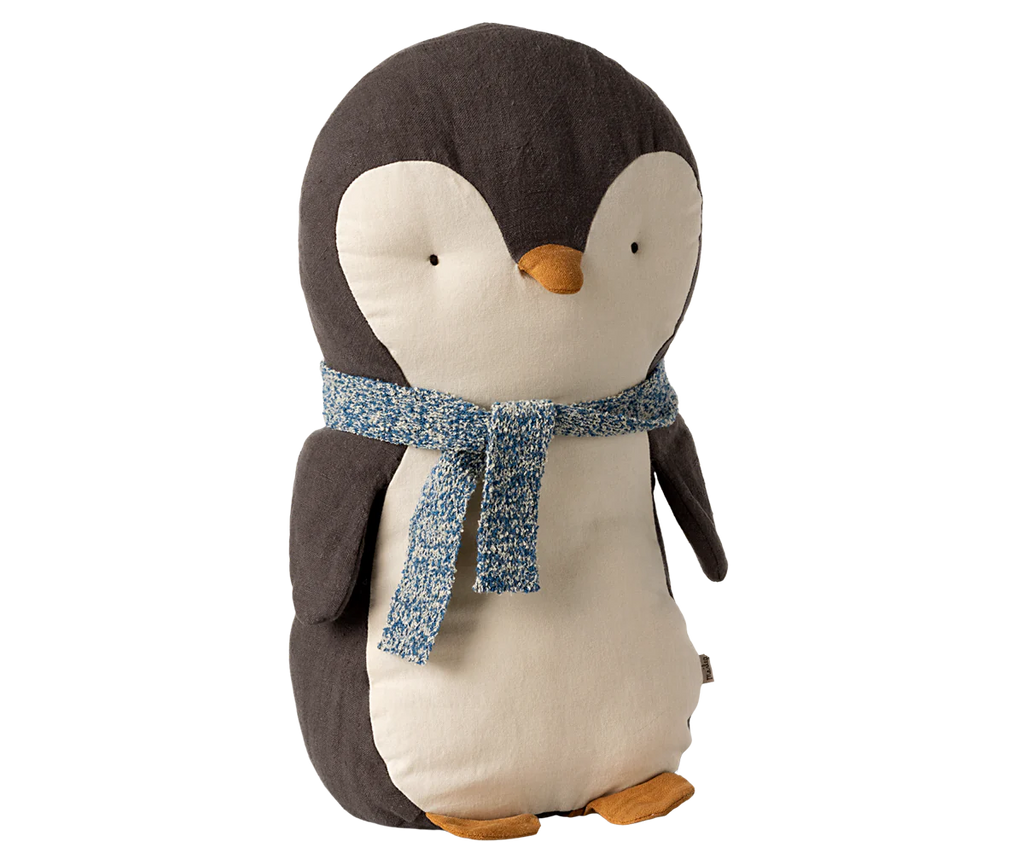 Introducing the Maileg Penguin Stuffed Animal - Medium, this adorable plush showcases a dark grey back and white belly complemented by a playful blue patterned scarf. Crafted from soft fabrics, it features charming details like a small orange beak and flippers, standing proudly against a plain backdrop. A delightful companion for all ages!