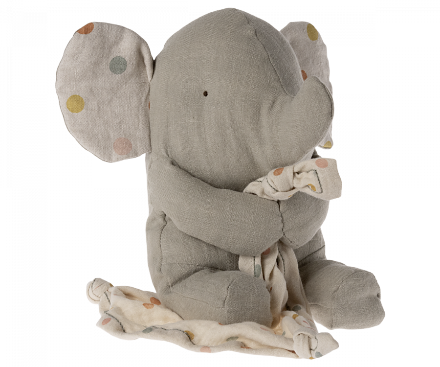 A Maileg Lullaby Friends - Elephant - Iron grey (Plays Music) made from gray fabric with large, floppy ears that have multicolored polka dots. Sitting and holding a knotted cloth with similar patterns, this baby toy is soft and cuddly. Imagine it as the perfect addition to a gift box while playing Mozart's lullaby softly in the background.